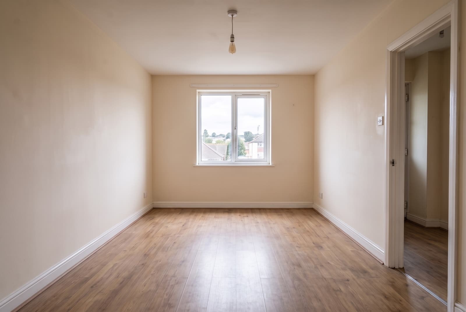 The same empty Devon room after an end-of-tenancy clean, flooring even and walls uniform and bright